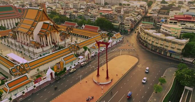 An aerial view of Red Giant Swing and Suthat Thepwararam Temple at sunset scene, The most famous tourist attraction in Bangkok, Thailand.
