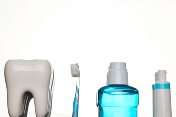 A toothbrush with toothpaste and mouthwash on white background