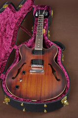 Obraz na płótnie Canvas Hollow electric guitar in a case. Jazz guitar.