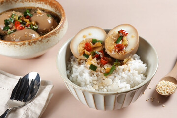 Mayak Gyeran is Korean Marinated Eggs with soy sauce, chili, garlic, honey, water, spring onion and sesame seed, served with rice. 