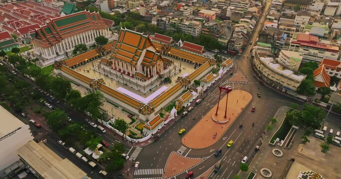 An aerial view of Red Giant Swing and Suthat Thepwararam Temple at sunset scene, The most famous tourist attraction in Bangkok, Thailand.