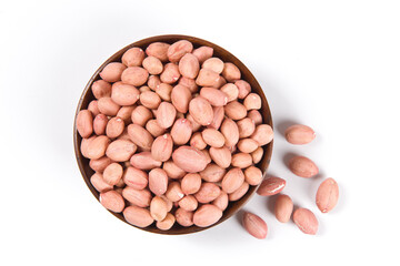 Raw peanuts in a wooden plate isolated on white background.