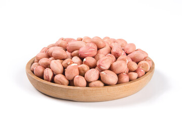Raw peanuts in a wooden plate isolated on white background.