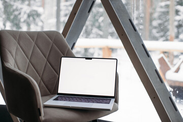 laptop on the table with space for text. winter outside the window 14-inch MacBook Pro