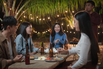 Group of young friends gets together for a party in the backyard.