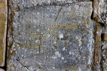 old roman text on the stone wall, Butrint, Albania