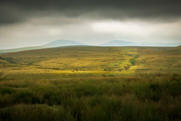 The moody landscape of the Brecon Beacons National Park in Wales, UK just beform a storm.