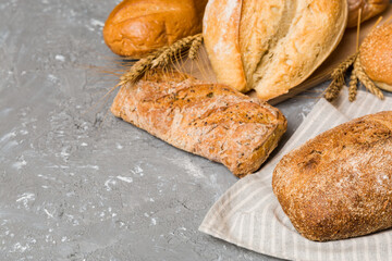 Homemade natural breads. Different kinds of fresh bread as background, perspective view with copy space