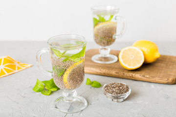 Healthy breakfast or morning with chia seeds lemon and mint on table background, vegetarian food, diet and health concept. Chia pudding with lemon and mint