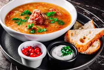 vegetables soup with meat in white bowl on table