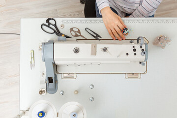 Top view sewing machine with sewing tools, scissors, thread