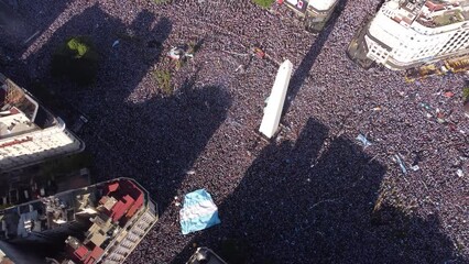 Incredible crowd of Argentina football fans celebrating in 9th July Avenue around obelisk the final victory of soccer World Cup 2022, Buenos Aires. Aerial drone top-down view