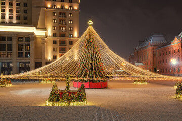 Moscow, Russia - December 7, 2022: Big Christmas tree. New Year decorations and Christmas atmosphere on a winter street in Moscow
