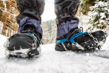 Fototapeta na wymiar Crampons on hiking boot. Hiking in winter