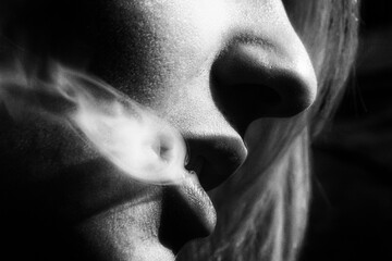 Smoke coming from the mouth of the young girl face