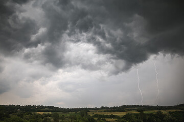 Storm clouds and lightning over the countryside