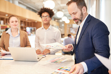 Manager with color scheme and creative designer team