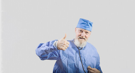 Infectious disease doctor with a gray beard in a blue protective overalls shows a thumbs up