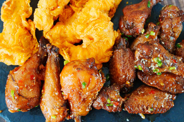 caramelized chicken with sesame and garlic, meat strips in breadin.