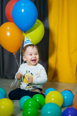 Fototapeta na wymiar Babies First Birthday. One year old with colorful balloons. The boy's birthday.