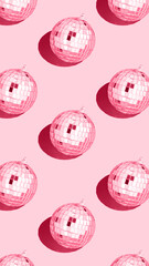 Color of the year 2023 viva magenta..Shiny disco ball. Creative Christmas pattern. 90s retro party time concept. Xmas holiday background. Top view. Flat lay.