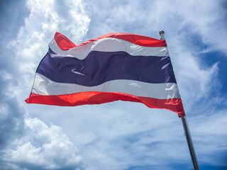 National flag of Thailand blowing in the wind on the blue sky. The flag of Thailand shows the color of red ,white and blue in five horizontal stripes which said to stand for nation-religion-king.