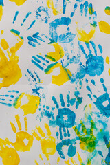 bright prints of children's hands from paint on the wall, background, texture