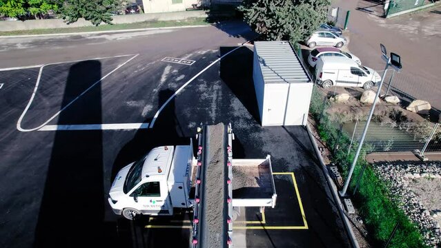 Drone shot of concrete getting loaded on to truck in Nîmes, France