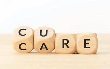 Care to cure concept.Text on wooden blocks and changing dices