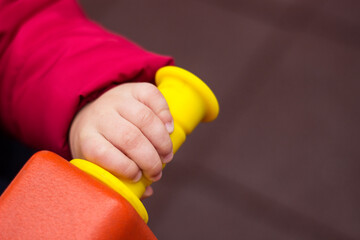 Hand of baby boy ride a motorcycle