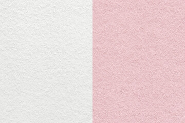 Fototapeta premium Texture of craft light pink and white paper background, half two colors, macro. Structure of vintage rose cardboard.