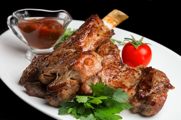 Fried meat on the bone with barbecue sauce and parsley