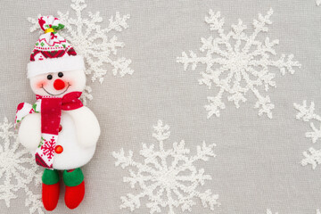 Snowman on white and gray snowflakes