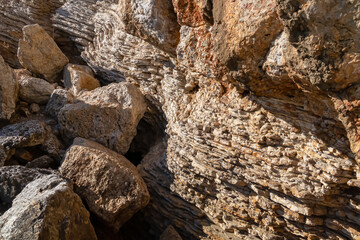 Unique pancake rock formations on idyllic walk along steep high cliffs to the central beach Mogren of coastal tourist city of Budva, Montenegro, Adriatic Mediterranean Sea, Montenegro, Balkan, Europe