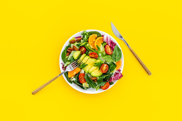Vegan meal with healthy green salad - avocado and tomatoes in bowl