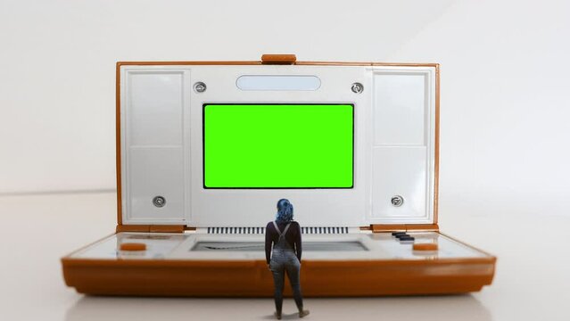 Retro Video Game Girl Standing Old Console Green Screen. Woman standing in front of an old video game console green screen. Surreal Scene