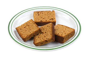 Slices of Dutch honey cake on a plate isolated on a white background.