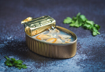 Canned clams open on a dark blue table with parsley. Ready for eat. 