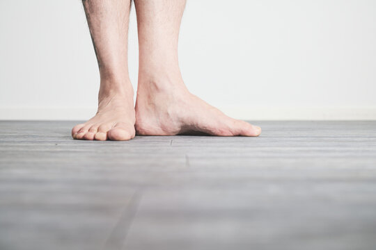 Male feet barefoot on floor