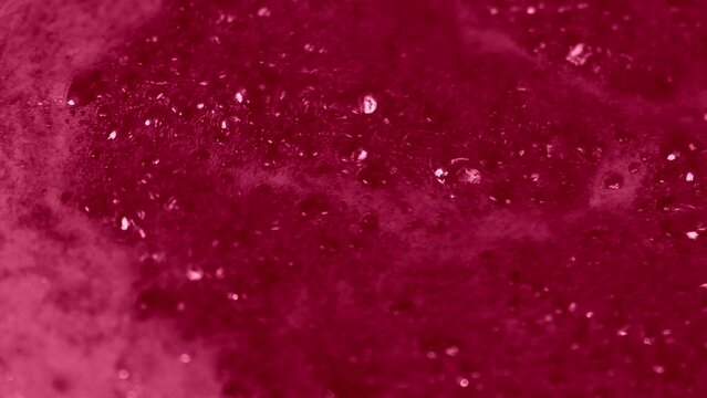 Raspberry Jam Foam. Cooking Marmalade from Berrie Cherry, Strawberry. Rich Red Sweet Confiture made with Bubbles, Thick Foam. Pink Bubbling Liquid Boiling Texture. Macro shot of Cranberry Jam. Magenta