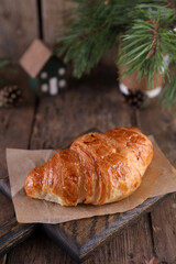 Croissant on a wooden board on a wooden board