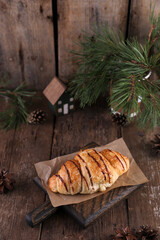 Croissant with chocolate on a wooden board on a wooden board