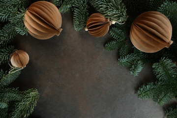Christmas toys made of handmade paper. Handmade work. Craft paper.Fir branches. Flat view.Space for text. A greeting card for the holiday.New Year or Christmas.
