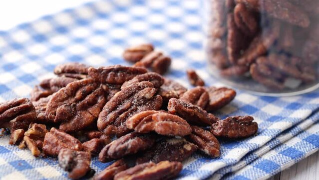 Tasty pecan-nut on a wooden board on white color table 