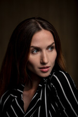 Fototapeta premium portrait of a young attractive woman on a dark background
