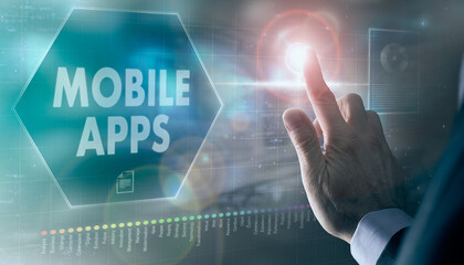 A businessman controlling a futuristic display with a Mobile Apps business concept on it.