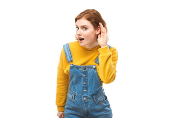 Young redhead woman in casual wear smiling and holding hand near ear, listening carefully, hearing...