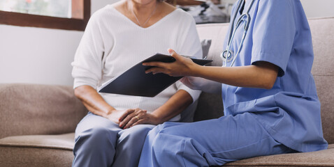 Fototapeta premium Homecare nursing service and elderly people cardiology healthcare. Close up of young hispanic female doctor nurse check mature caucasian man patient heartbeat using stethoscope during visit