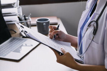 Fototapeta premium Homecare nursing service and elderly people cardiology healthcare. Close up of young hispanic female doctor nurse check mature caucasian man patient heartbeat using stethoscope during visit