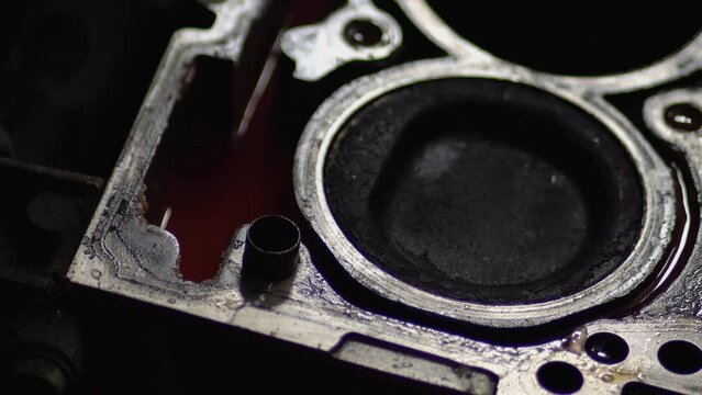 Disassembled motor engine of a car on a repair at the mechanic. The cylinder block of the four-cylinder engine. Closeup